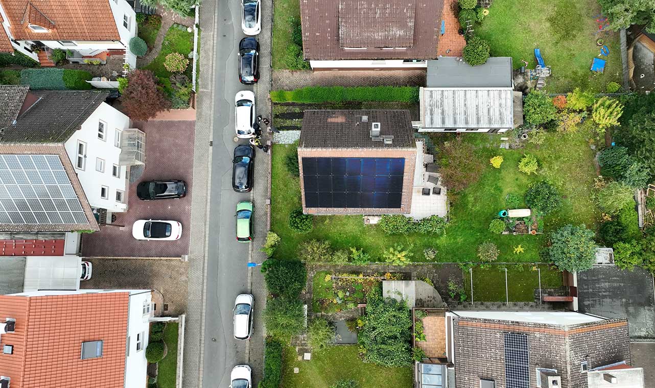 Overhead view of residential rooftop solar panel system equipped with Solavita hybrid inverter and 5.12kWh battery pack, highlighting efficient energy storage solutions