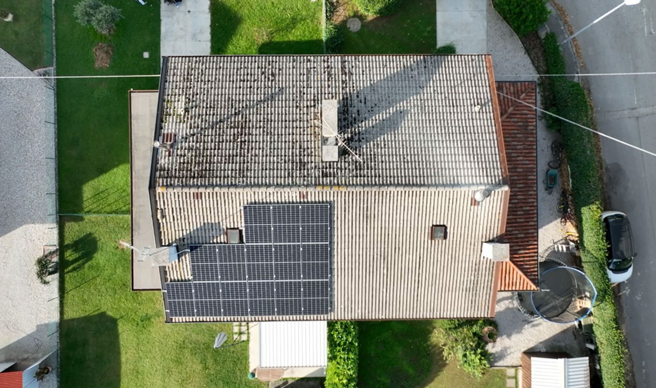 Overhead view of residential rooftop solar panel system equipped with Solavita hybrid inverter and 5.12kWh battery pack, highlighting efficient energy storage solutions