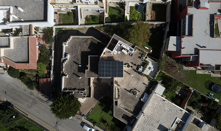 Overhead view of residential rooftop solar panel system equipped with Solavita hybrid inverter and 10.24kWh battery pack, highlighting efficient energy storage solutions