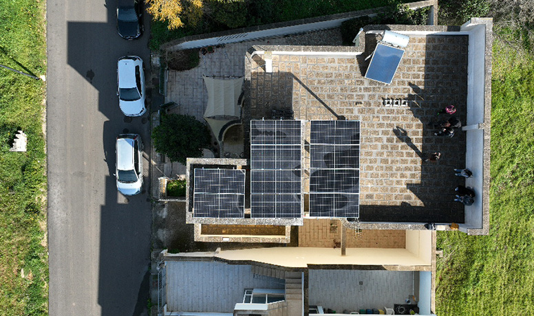 Top-down view of rooftop solar panel installation with Solavita hybrid inverter and battery pack integration, showcasing efficient residential renewable energy solutions